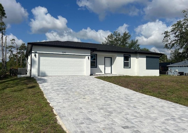 3045 Montgomery Dr, Port Charlotte, FL 33981 - ranch-style home with stucco siding, decorative driveway, an attached garage, and a front lawn
