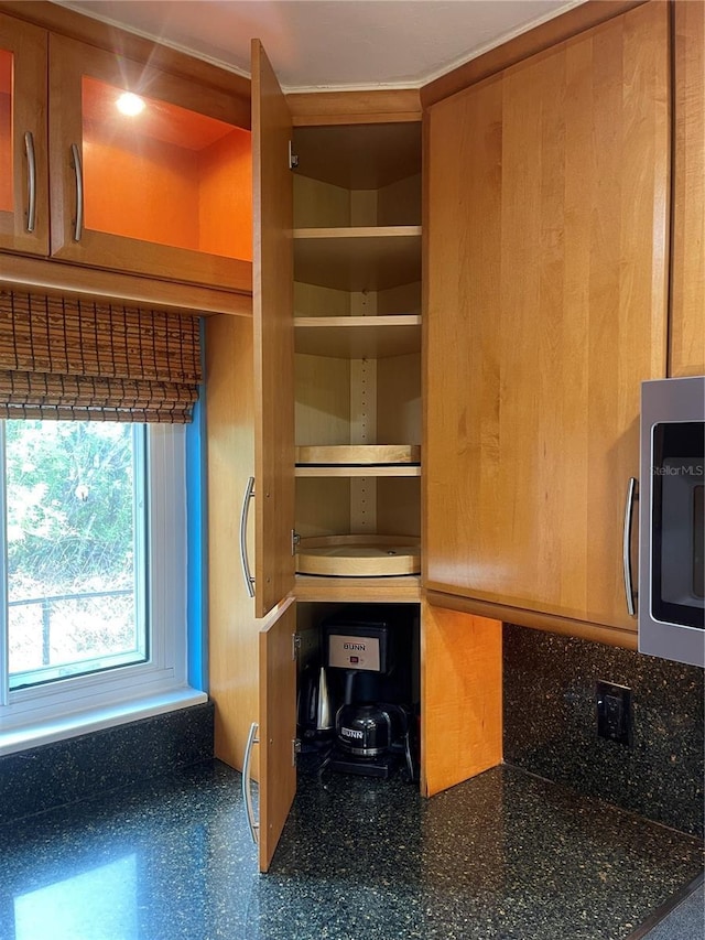 3027 Ridgewood Dr, North Port, FL 34287 - kitchen view of stainless steel microwave, open shelves, and dark countertops