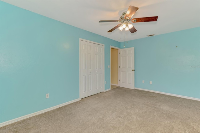 3027 Ridgewood Dr, North Port, FL 34287 - unfurnished bedroom with carpet floors, baseboards, a closet, and a ceiling fan