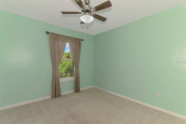 3027 Ridgewood Dr, North Port, FL 34287 - empty room featuring light colored carpet, ceiling fan, and baseboards