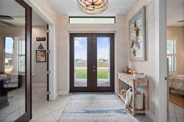 3527 NW 8th Ter, Cape Coral, FL 33993 - entryway featuring french doors, light tile patterned floors, ceiling fan, and a chandelier