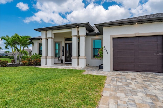 3527 NW 8th Ter, Cape Coral, FL 33993 - view of front of home with stucco siding, a front yard, and an attached garage