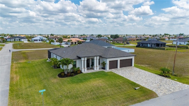 3527 NW 8th Ter, Cape Coral, FL 33993 - view of front of home featuring a residential view, a garage, decorative driveway, and a front yard