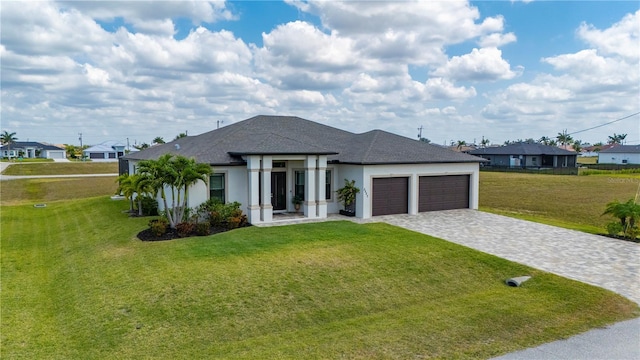 3527 NW 8th Ter, Cape Coral, FL 33993 - view of front of property featuring a garage, a front lawn, stucco siding, and roof with shingles