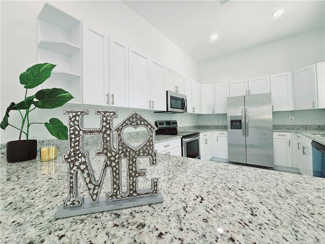 kitchen featuring stainless steel appliances, light stone counters, open shelves, white cabinets, and recessed lighting