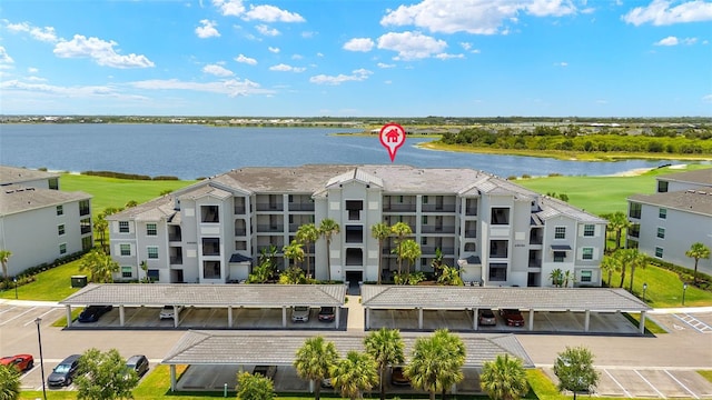 aerial view of a large body of water, apartment complex, and a golf course