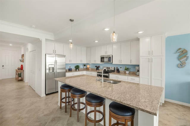 kitchen featuring stainless steel appliances, a sink, white cabinetry, recessed lighting, and a breakfast bar area