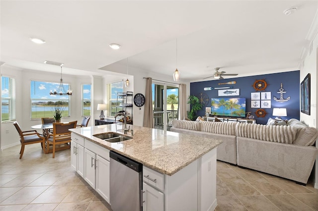 kitchen with a sink, dishwasher, open floor plan, white cabinetry, and light tile patterned flooring