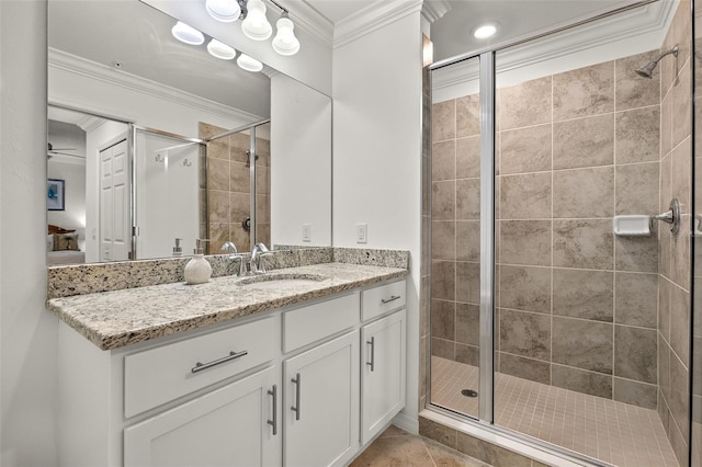 ensuite bathroom featuring crown molding, a stall shower, vanity, and tile patterned floors