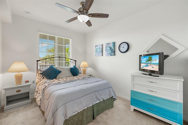 bedroom with light carpet, baseboards, and ceiling fan