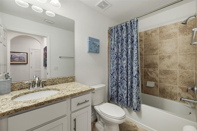 bathroom featuring toilet, shower / tub combo, and vanity