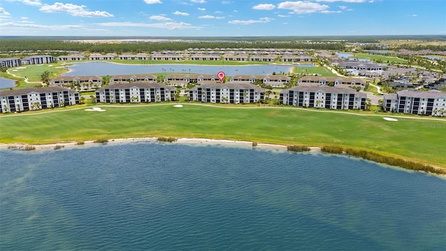 aerial view of residential area featuring a large body of water and a golf course