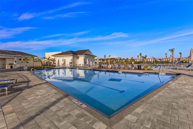 community pool with a patio area and a residential view