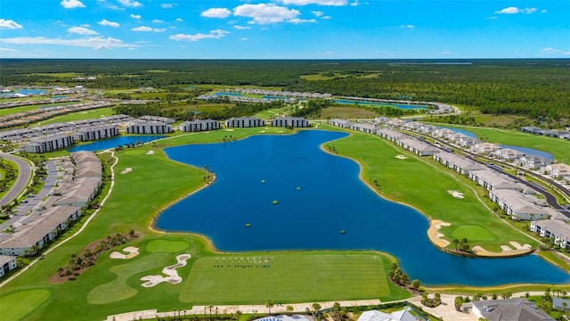 bird's eye view of a golf course, a large body of water, and a forest