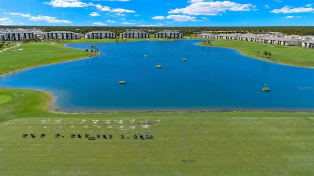 aerial view of apartment complex / building, a local golf course, and a large body of water