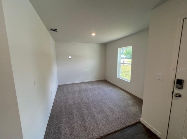 76 Raleigh Dr, Palm Coast, FL 32164 - unfurnished room with baseboards, dark carpet, and recessed lighting