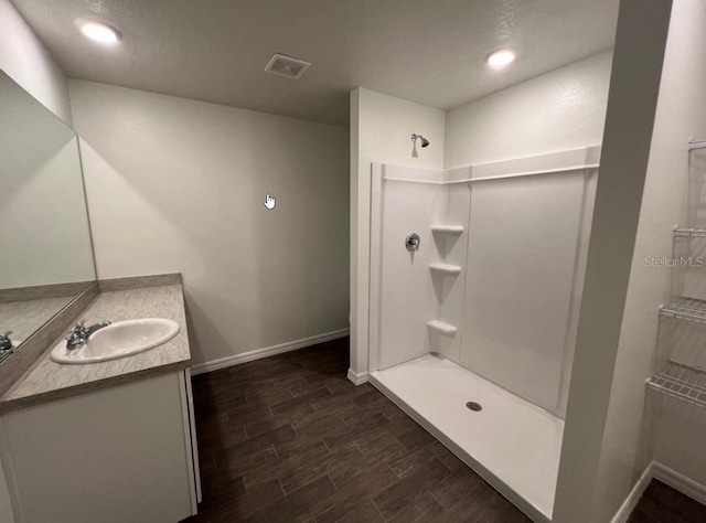 76 Raleigh Dr, Palm Coast, FL 32164 - full bath with a shower, vanity, baseboards, and wood finished floors