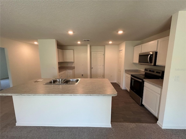 6 Whittier Ln, Palm Coast, FL 32164 - kitchen featuring stainless steel appliances, a sink, recessed lighting, white cabinetry, and an island with sink