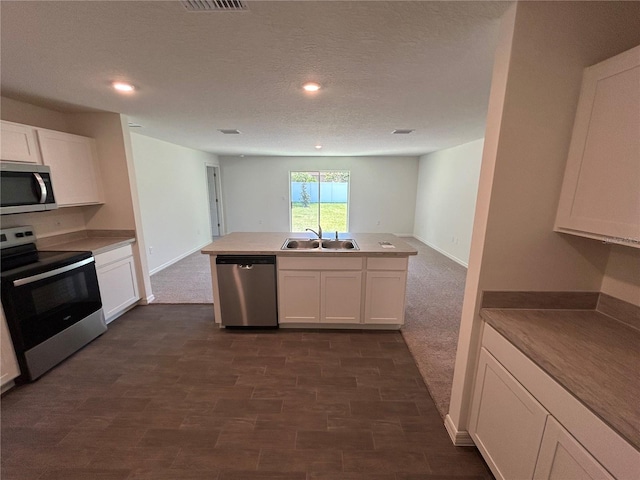 6 Whittier Ln, Palm Coast, FL 32164 - kitchen with stainless steel appliances, a sink, white cabinets, recessed lighting, and a textured ceiling