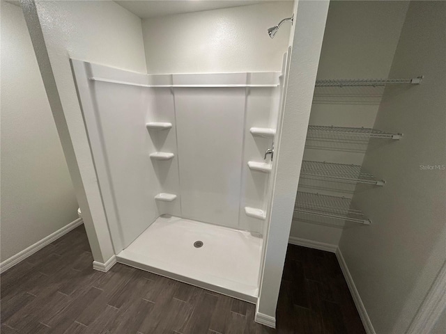 6 Whittier Ln, Palm Coast, FL 32164 - full bath with wood finished floors, a shower stall, and baseboards