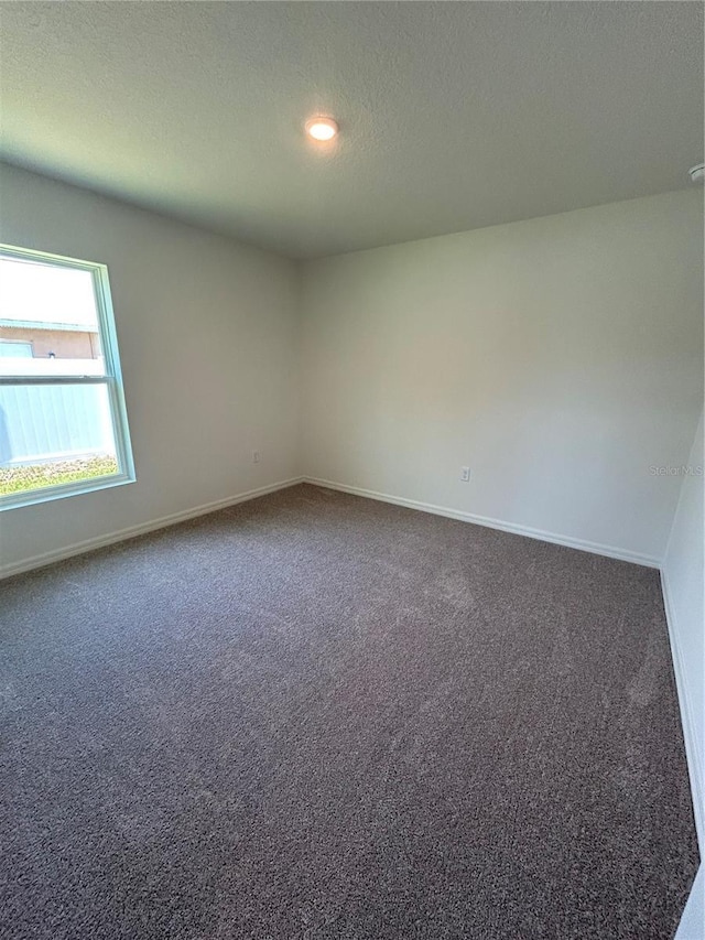 6 Whittier Ln, Palm Coast, FL 32164 - spare room with carpet, baseboards, a textured ceiling, and recessed lighting