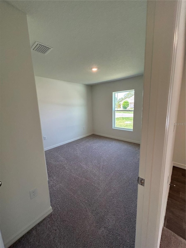 6 Whittier Ln, Palm Coast, FL 32164 - empty room featuring dark colored carpet, baseboards, and recessed lighting
