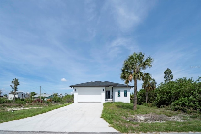 3920 Wisteria Pl, Punta Gorda, FL 33950 - prairie-style house with stucco siding, driveway, and a garage