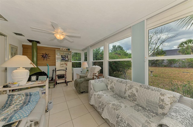 12018 Saragossa Ln, North Port, FL 34287 - sunroom featuring tile patterned floors, a ceiling fan, an outdoor living space, and a wood stove