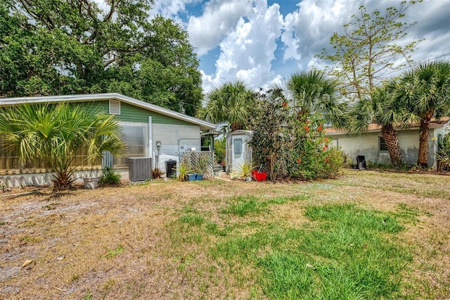 12018 Saragossa Ln, North Port, FL 34287 - view of grassy yard with a shed, central air condition unit, and an outbuilding