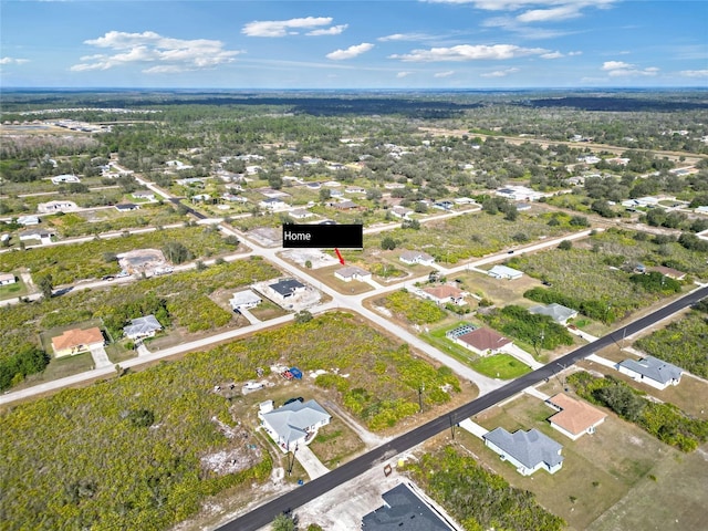 aerial view of property and surrounding area featuring nearby suburban area