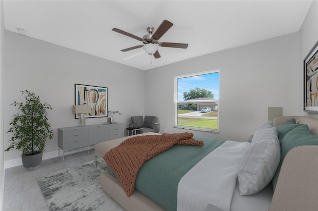 bedroom featuring baseboards and a ceiling fan