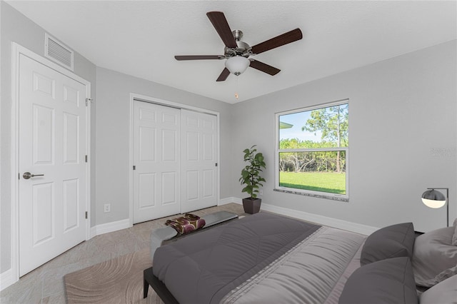 bedroom featuring baseboards, a closet, and a ceiling fan