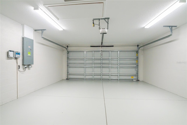 garage featuring electric panel and concrete block wall