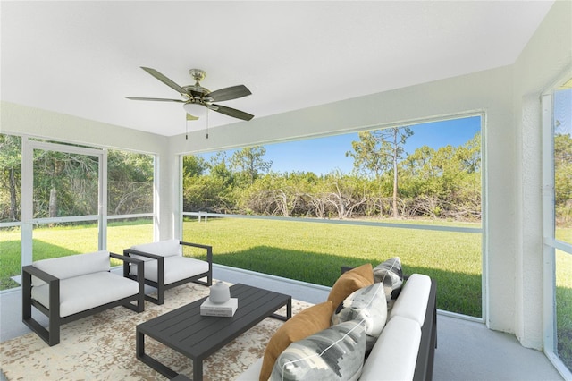 sunroom / solarium with ceiling fan and an outdoor living space
