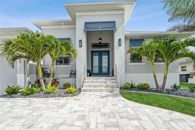 1306 Osprey Dr, Punta Gorda, FL 33950 - property entrance featuring french doors and stucco siding