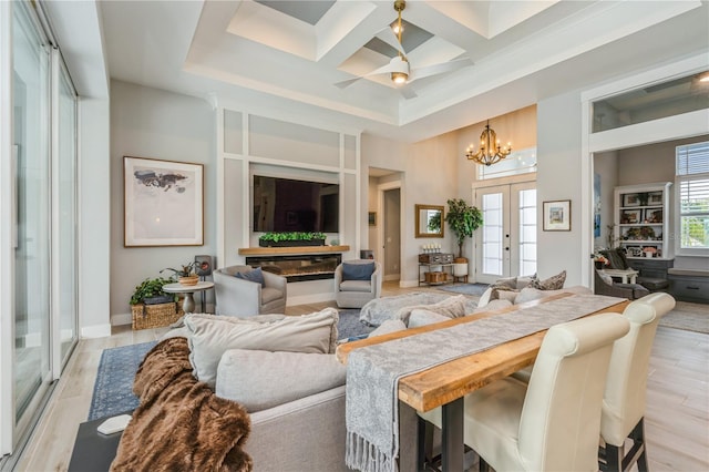 1306 Osprey Dr, Punta Gorda, FL 33950 - living area featuring a chandelier, a towering ceiling, coffered ceiling, light wood-style floors, and a ceiling fan
