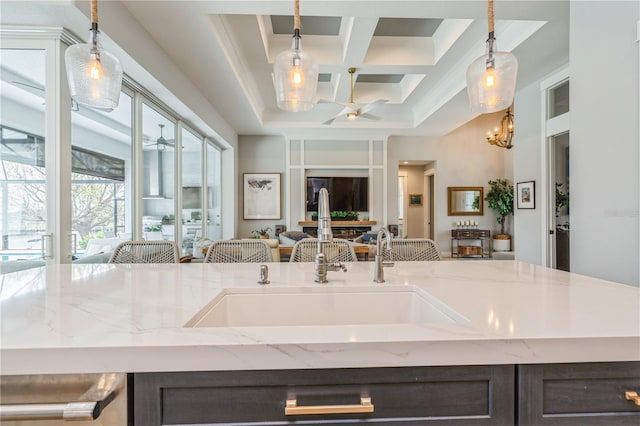 1306 Osprey Dr, Punta Gorda, FL 33950 - kitchen with open floor plan, coffered ceiling, light stone countertops, a chandelier, and a sink