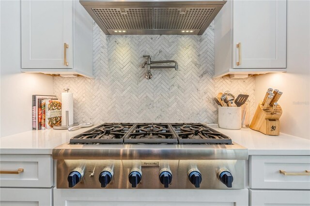 1306 Osprey Dr, Punta Gorda, FL 33950 - kitchen with ventilation hood, stainless steel gas stovetop, decorative backsplash, and light countertops