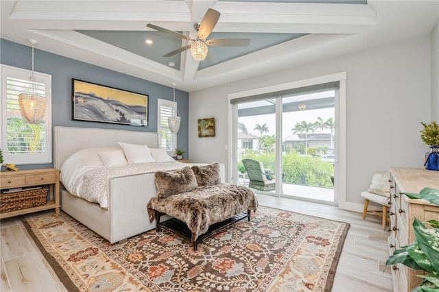 1306 Osprey Dr, Punta Gorda, FL 33950 - bedroom featuring access to outside, a tray ceiling, a ceiling fan, light wood-style floors, and baseboards