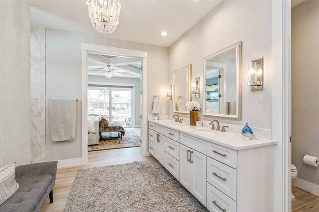 1306 Osprey Dr, Punta Gorda, FL 33950 - full bathroom with coffered ceiling, double vanity, toilet, beam ceiling, and ceiling fan