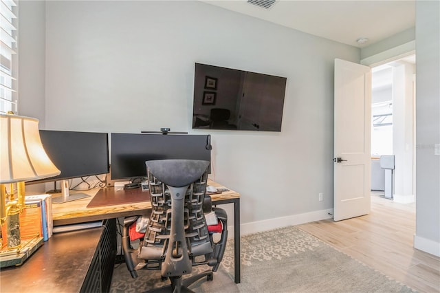 1306 Osprey Dr, Punta Gorda, FL 33950 - office area with healthy amount of natural light, wood finished floors, and baseboards