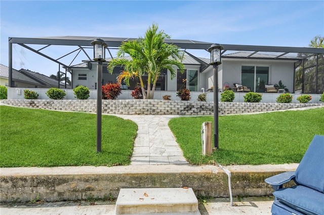 1306 Osprey Dr, Punta Gorda, FL 33950 - view of front facade featuring a lanai, a front yard, and stucco siding