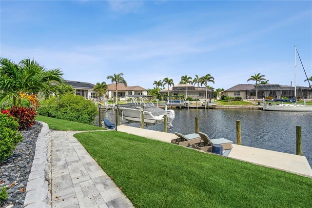 1306 Osprey Dr, Punta Gorda, FL 33950 - dock area with boat lift, a residential view, a water view, and a yard