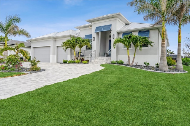 1306 Osprey Dr, Punta Gorda, FL 33950 - view of front of property featuring stucco siding, an attached garage, a front lawn, and decorative driveway