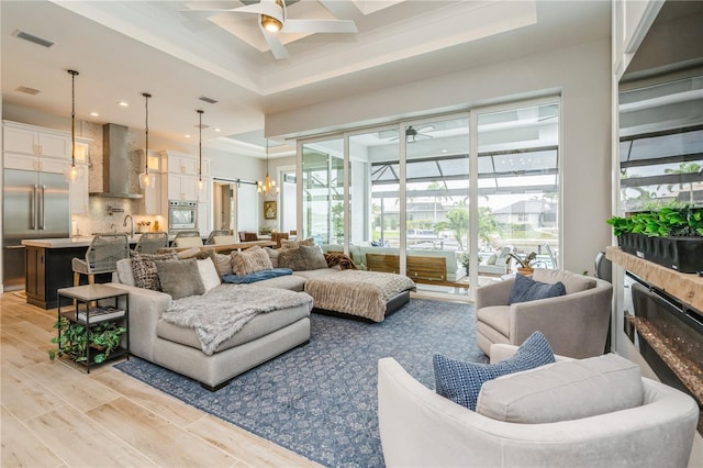 1306 Osprey Dr, Punta Gorda, FL 33950 - living area featuring ceiling fan, plenty of natural light, a raised ceiling, recessed lighting, and crown molding