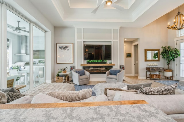 1306 Osprey Dr, Punta Gorda, FL 33950 - living room with ceiling fan, light wood-style floors, a raised ceiling, and baseboards