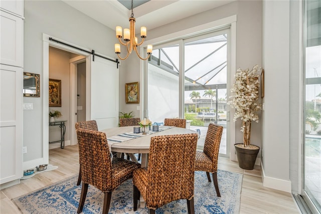 1306 Osprey Dr, Punta Gorda, FL 33950 - dining area with healthy amount of natural light, light wood-type flooring, a barn door, and baseboards