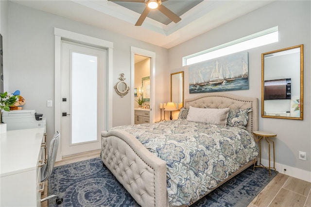 1306 Osprey Dr, Punta Gorda, FL 33950 - bedroom featuring wood finished floors, a raised ceiling, baseboards, a ceiling fan, and connected bathroom