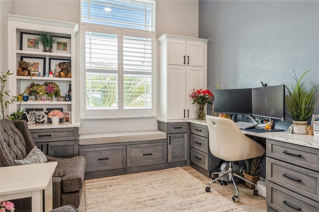 1306 Osprey Dr, Punta Gorda, FL 33950 - office area with healthy amount of natural light, a textured wall, and light wood-style flooring