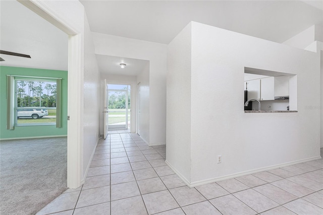 25046 Doredo Dr, Punta Gorda, FL 33955 - hall with light tile patterned flooring, healthy amount of natural light, and baseboards